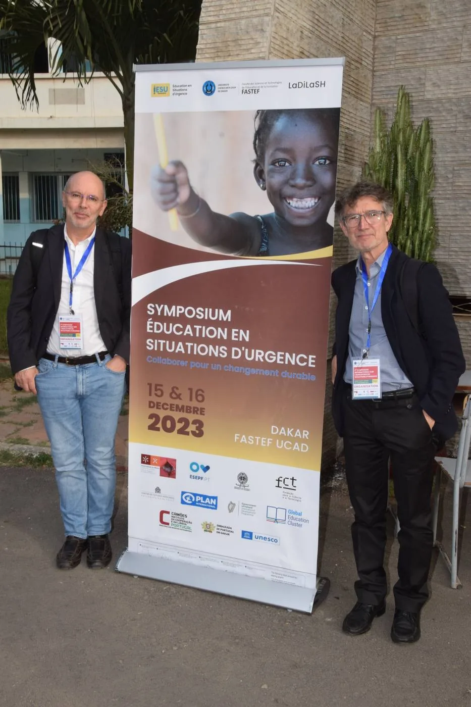 Participants by the symposium banner